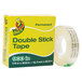A roll of Duck brand clear permanent double-stick tape in a yellow and green box.