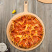 A pepperoni pizza on a Epicurean Richlite wood pizza board.