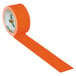 A roll of neon orange Duck Tape with the word "Duck" on it.