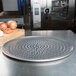 An American Metalcraft Super Perforated Heavy Weight Aluminum Coupe Pizza Pan. A metal tray with holes in it.