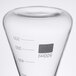 An American Metalcraft Erlenmeyer flask glass with measurements on a counter.