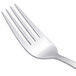 An Arcoroc stainless steel dessert fork with a silver handle.