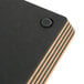 A black rectangular Epicurean wood fiber cutting board with brown stripes.