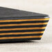 A black Epicurean cutting board with yellow accents.