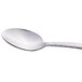 A close-up of a Libbey stainless steel demitasse spoon with a textured handle.