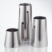 Three American Metalcraft stainless steel creamers on a white surface.