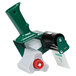 A Duck Tape green and white tape dispenser with a red handle and a red wheel on a white background.