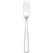 An Arcoroc stainless steel serving fork with white handles.