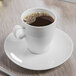 A Schonwald white porcelain saucer with a cup of coffee on it.