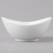 A Schonwald Grace white porcelain dip dish with a curved edge.