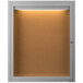 An Aarco satin anodized indoor lighted bulletin board with a white background and cork board inside.