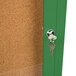An Aarco green enclosed bulletin board cabinet with a key in the lock.