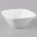 A Schonwald Continental White square porcelain bowl with a small rim on a gray background.