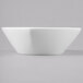 A Schonwald white porcelain low bowl on a gray surface.