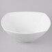 A Schonwald white porcelain square bowl with a white rim on a white surface