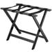 A black Lancaster Table & Seating wood folding luggage rack with straps.