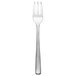 An Arcoroc stainless steel oyster fork with a white background.