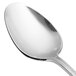 A close-up of a Chef & Sommelier stainless steel dessert spoon with a silver handle on a white surface.