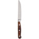 A Chef & Sommelier steak knife with a wooden handle and metal blade.