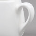 An American Metalcraft white porcelain creamer with a handle.