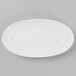 A Schonwald Grace white porcelain oval platter on a gray surface.