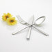 A fork and spoon crossed over a fork with flowers.