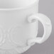 A close-up of a Schonwald white porcelain coffee mug with a handle.
