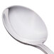 A close-up of a World Tableware Resplendence bouillon spoon with a silver handle.