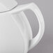 A close-up of a white Schonwald Avanti Gusto teapot with a lid and handle.