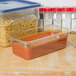 A Carlisle plastic food pan with pasta in it on a counter.