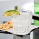 A Libbey Everest old fashioned glass with ice and a lime wedge.