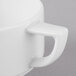 A close-up of a Schonwald white porcelain two-handled soup cup.