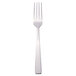 A silver Libbey Oceanside dinner fork with a white handle.
