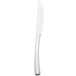 A Libbey stainless steel dinner knife with a white solid handle and a serrated blade.