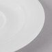 A close-up of a Schonwald white porcelain saucer with a white rim.