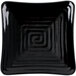 A black square plate with a spiral design.