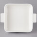 A white square dish with two handles.