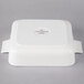 A white square porcelain serving dish with a lid.