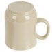 A close-up of a beige Thunder Group Nustone Sand mug with a white handle.
