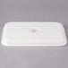 A white rectangular porcelain lid with a logo on it.