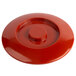 A red plastic lid with a round center.