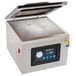 A VacPak-It chamber vacuum packaging machine with a digital display on a counter.