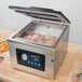 A VacPak-It chamber vacuum packaging machine with meat inside.