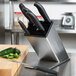 A Dexter-Russell knife block set on a counter with knives in it.
