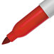 A close-up of a red Sharpie tip with white writing on it.