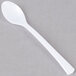 A close-up of a Fineline white plastic tasting spoon.