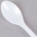 A Fineline white plastic tasting spoon.