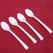 Three Fineline white plastic tasting spoons on a white background.