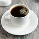 A Villeroy & Boch white porcelain cup of coffee on a saucer.