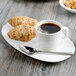 A white Villeroy & Boch porcelain cup filled with brown coffee on a saucer with croissants.